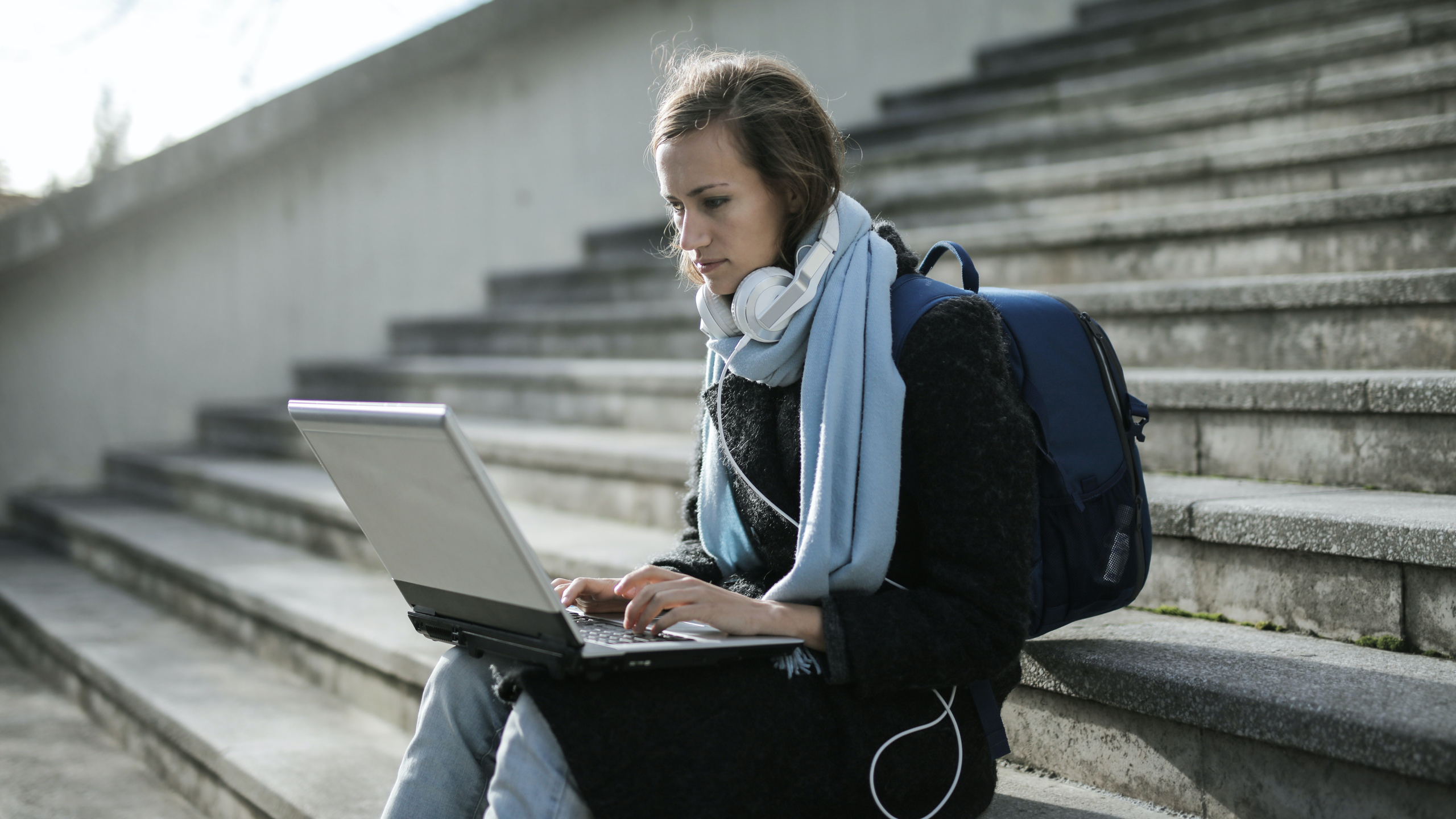 Woman with laptop and headphones