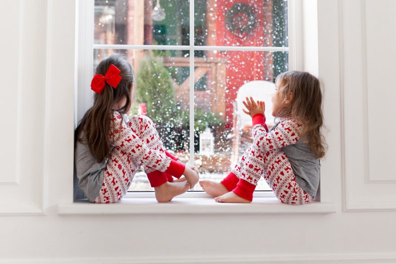 Children looking at snow from window.