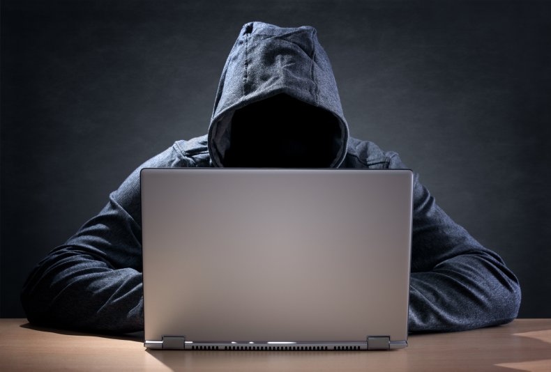 Hooded person on laptop