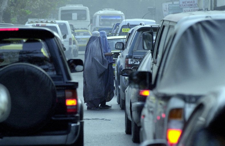 Two burka-clad Afghan woman beg for mone