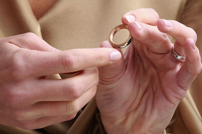 Person holding wedding ring