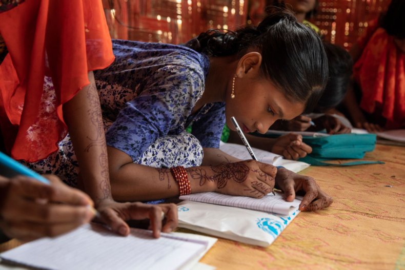Rohingya children write in books