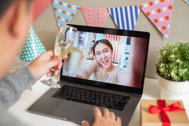 Two people celebrating on a video call.