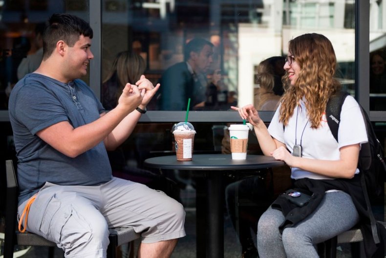 Two people speaking sign language