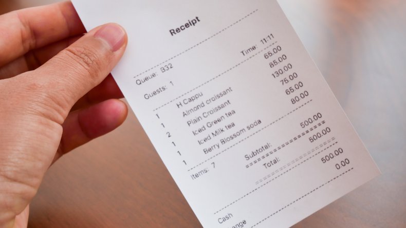 Receipt held in a hand
