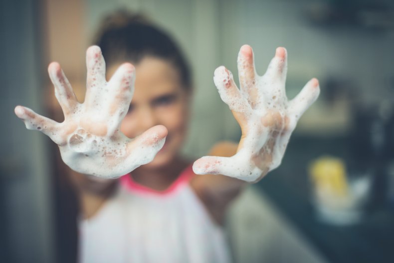 Little girl with soapy hands