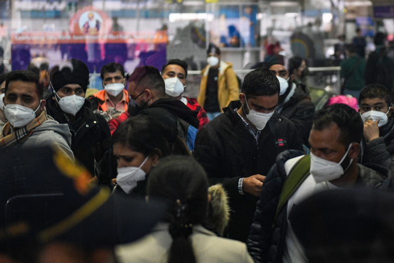 Passengers wait to undergo COVID testing