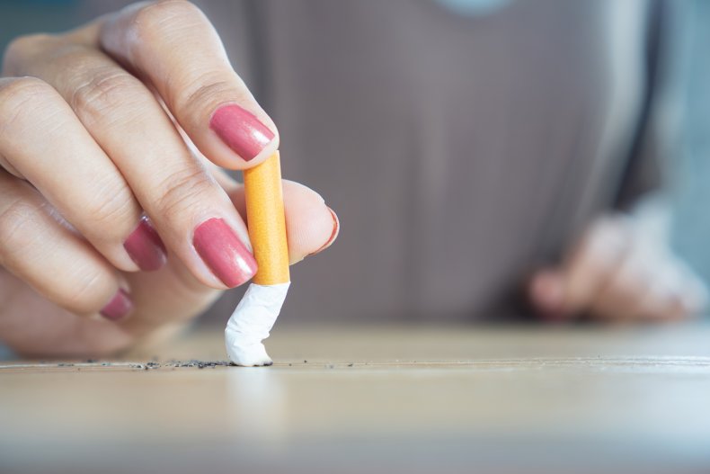 A woman crushing a cigarette