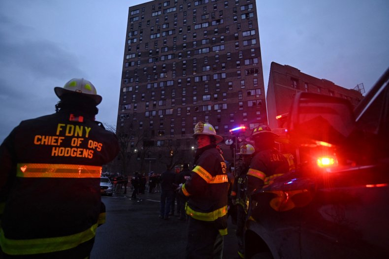 Firefighters work outside an apartment building