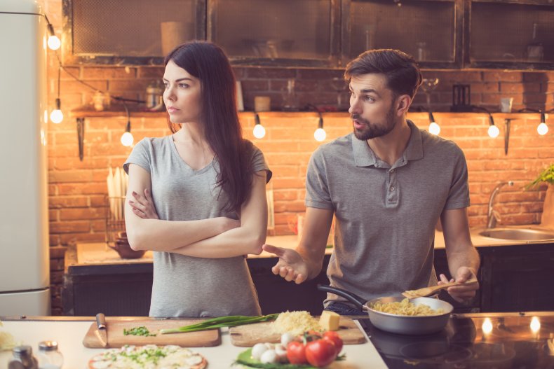 A man and a woman cooking food.