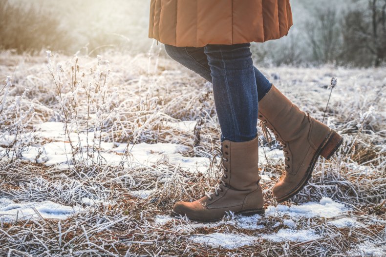 A woman walking through snowy woods
