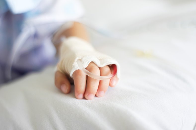 Child's hand with IV drip in hospital