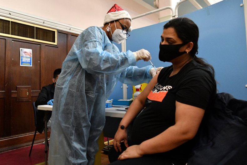 A health worker administers vaccine
