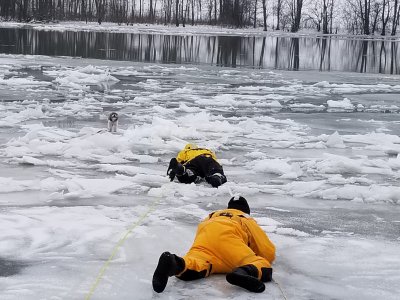 Fire fighters rescue dog on frozen river