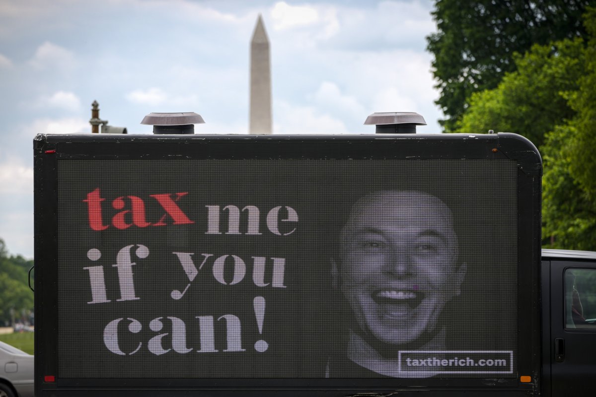 A mobile billboard featuring Elon Musk