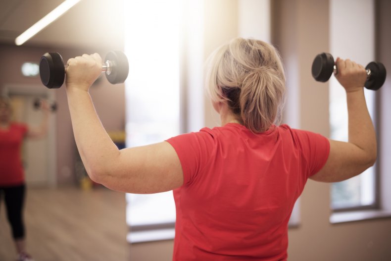 A woman holding dumbbells during exercise.