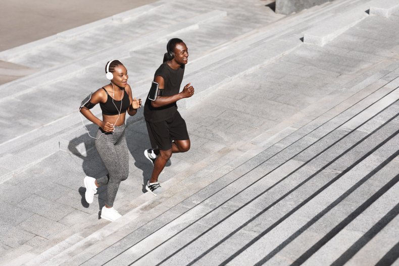 Two people run up stairs