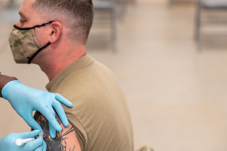 A soldier receives a COVID-19 vaccine