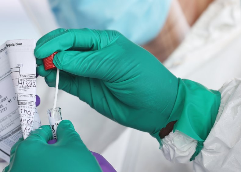 Health care worker seals a coronavirus swab
