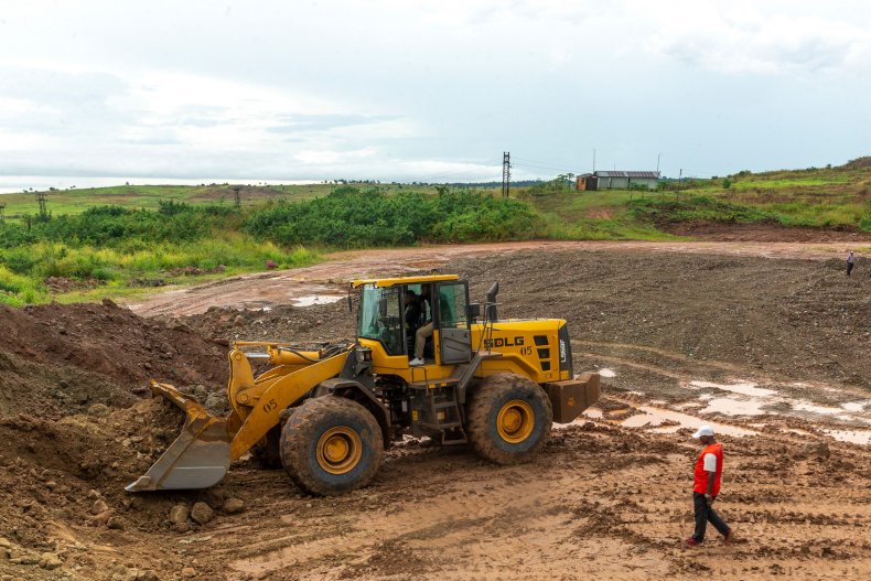 A worker driving a front loader
