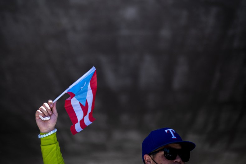 A person waves a Puerto Rican flag
