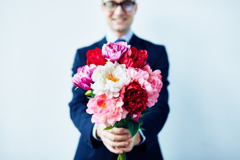 A man holding flowers. 