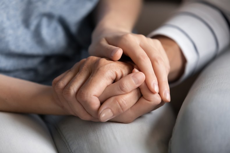 Stock image of two people holding hands