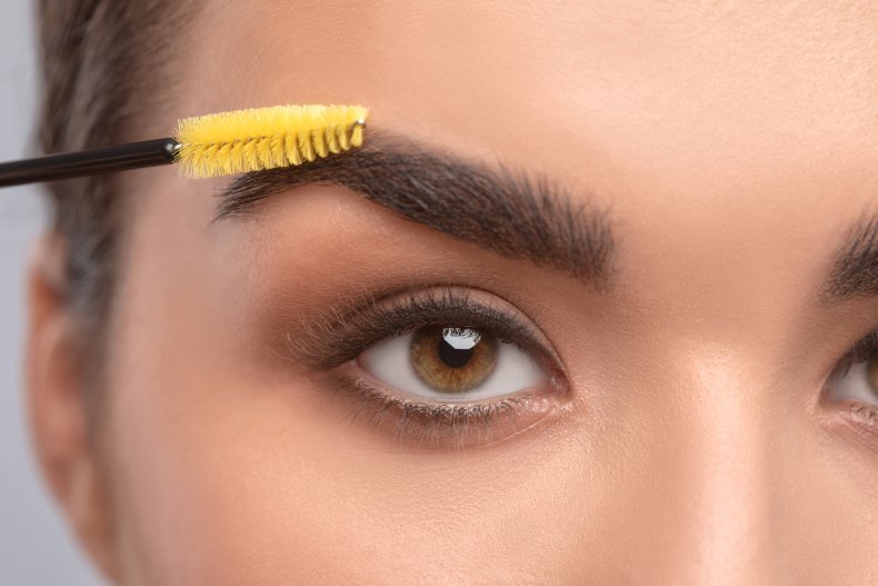 Mascara wand on eyebrow