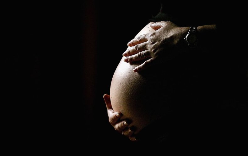 Pregnant woman holding belly