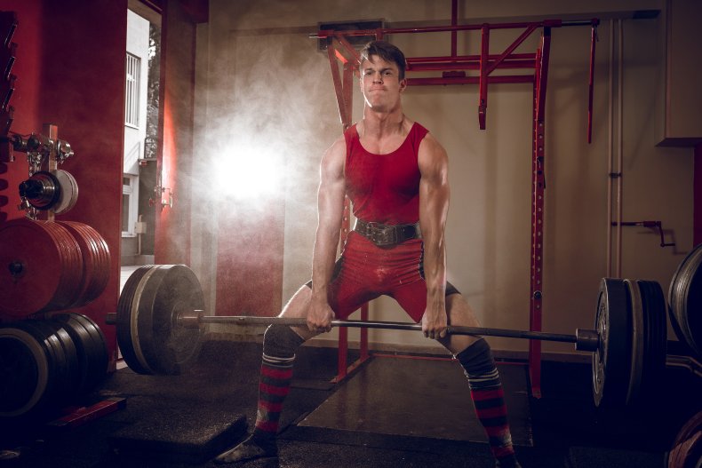 A man doing a sumo deadlift.