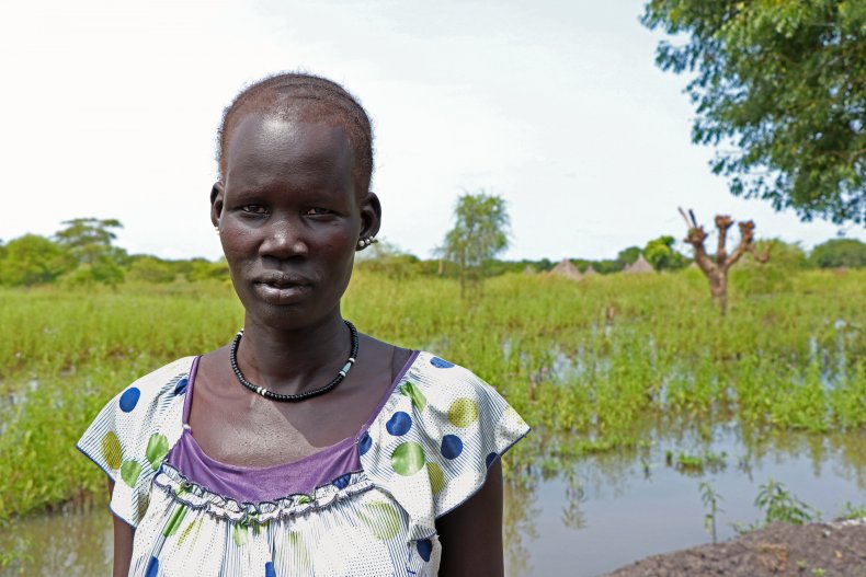 Puok in front of her inundated land