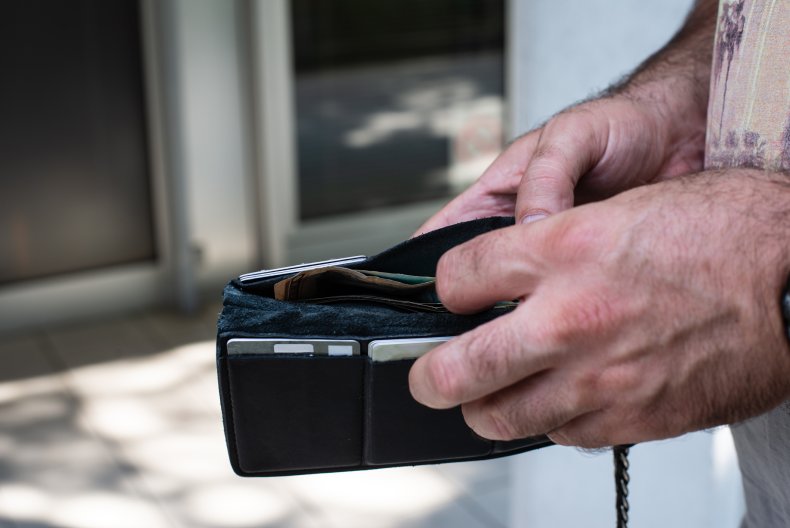 A man opening a wallet.