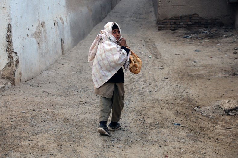 Afghanistan, child, holding, bread, Kandahar, February, 2022