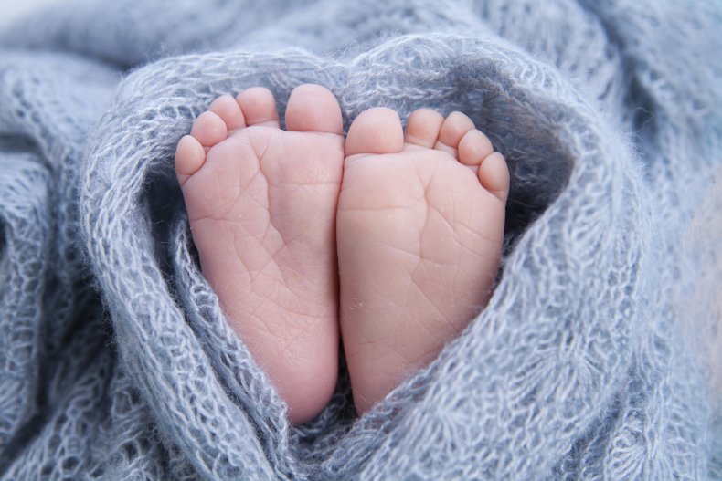 A newborn baby's feet in a blanket