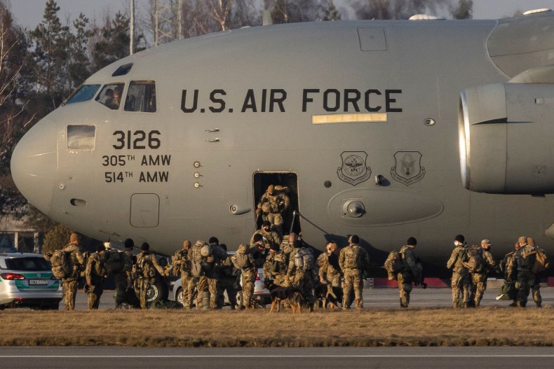 U.S. soldiers disembark from a cargo plane