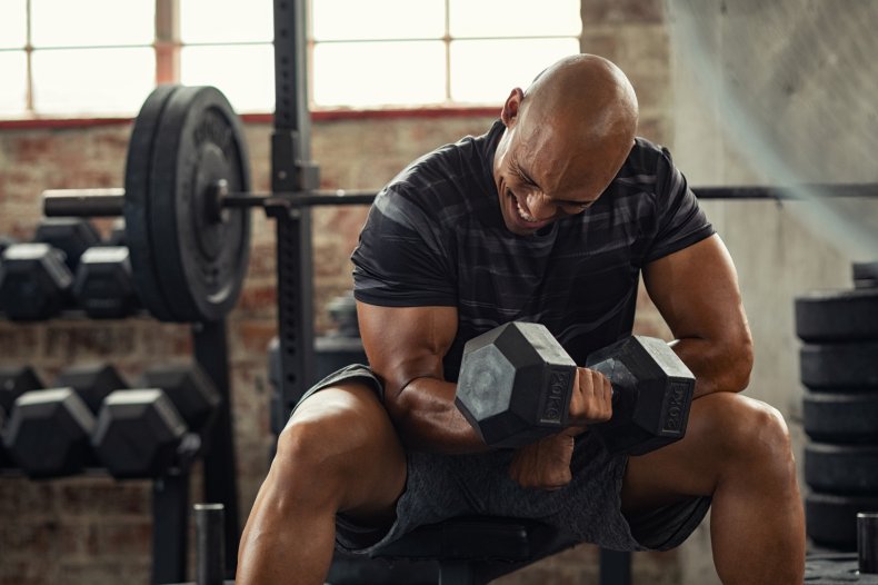 A man doing arm exercises using weights.