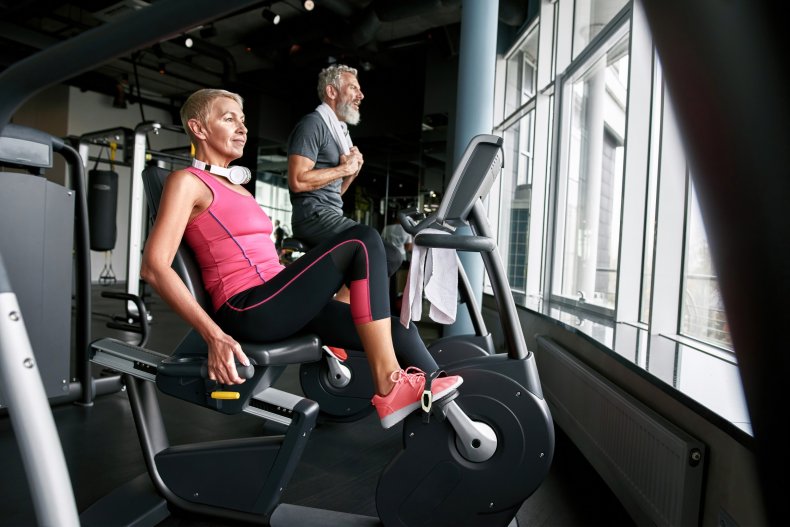 A woman on an exercise bike.
