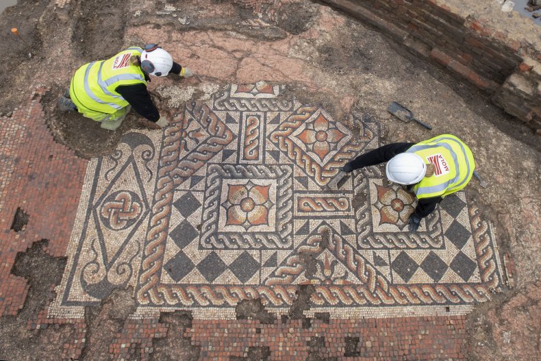 MOLA archaeologists work on the Roman mosaic.