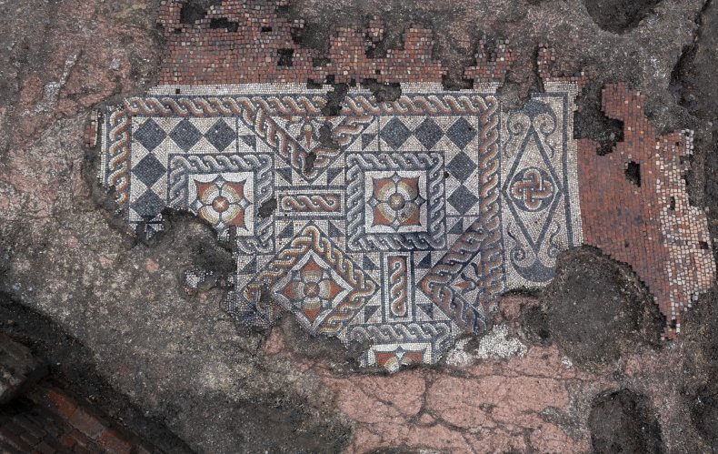 MOLA archaeologists work on the Roman mosaic.