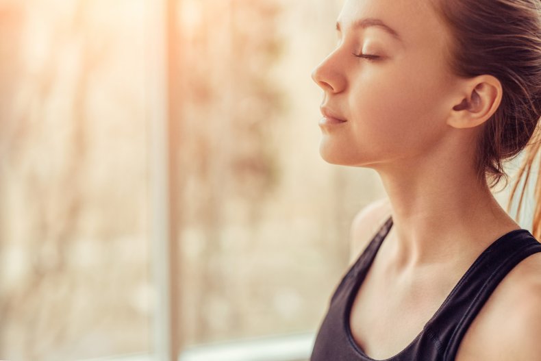 A woman relaxing with her eyes closed.