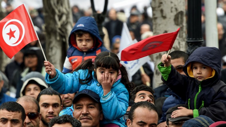 Tunisian children wave national flags