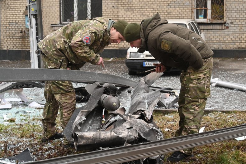 Ukraine soldiers in Kyiv inspect shell damage