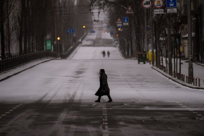 People walk along empty road in Kyiv