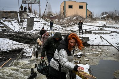 Ukraine civilians cross a rive near Ukraine