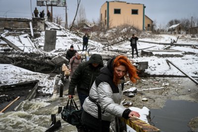 Ukraine civilians cross a rive near Ukraine Ukraine civilians cross a rive near Ukraine
