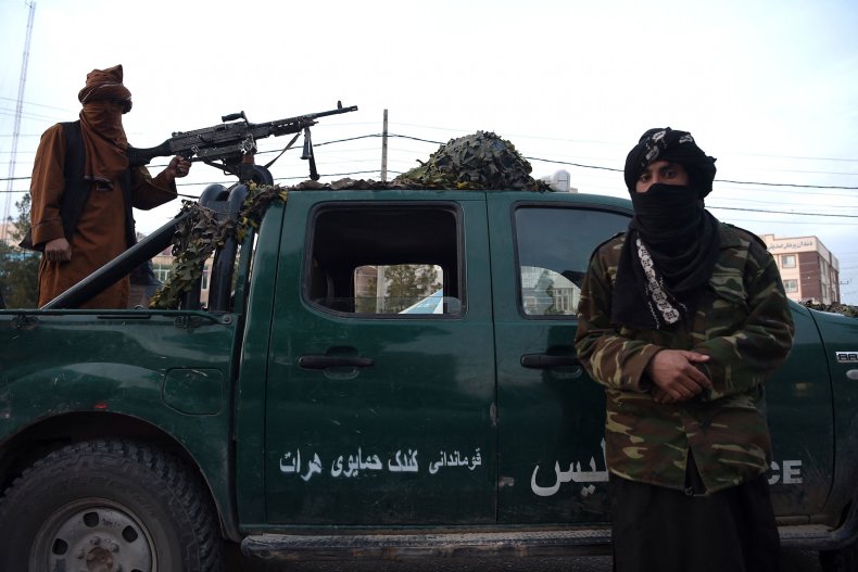 Taliban fighters stand guard