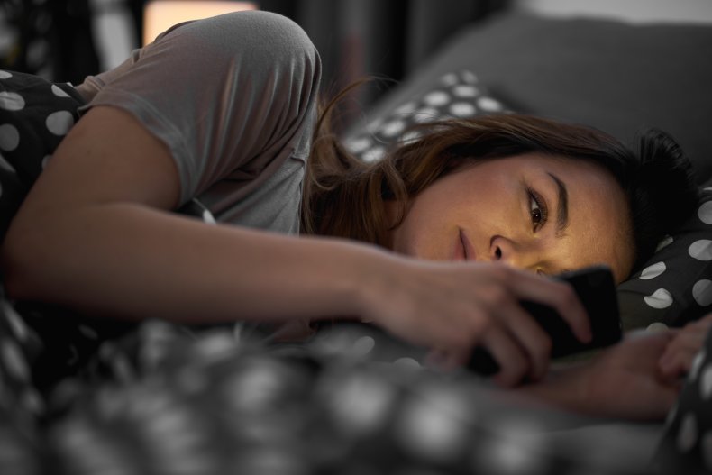 Woman reading texts in bed