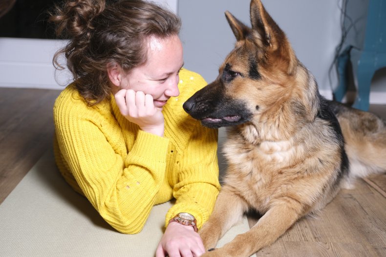 A woman sits with her German Shepard