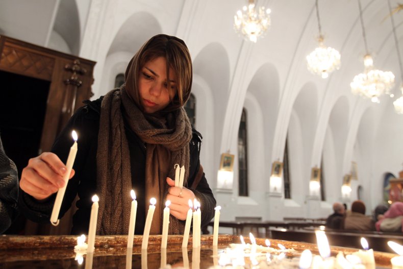 Iranian Christian woman lights candles