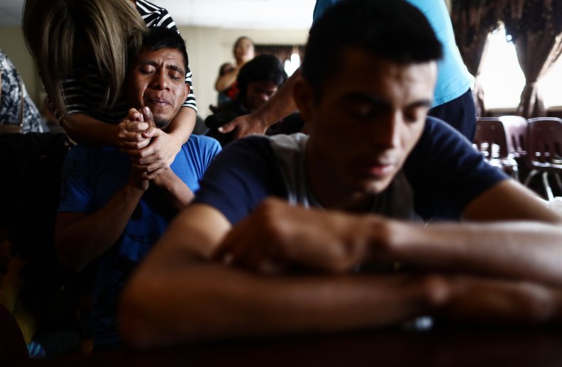 Recently arrived migrants pray